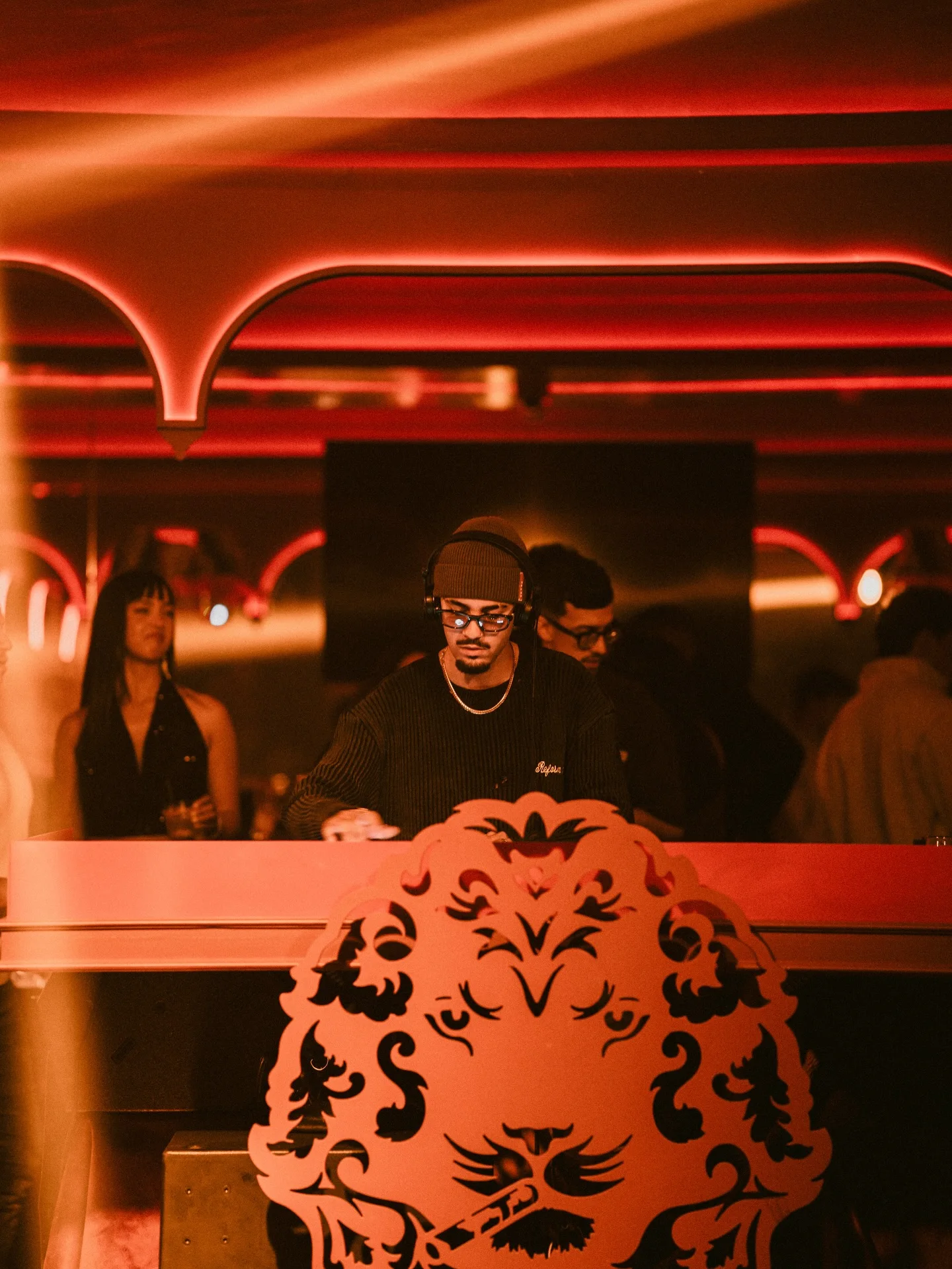 Resident DJ Alpha performing behind The Club lion booth